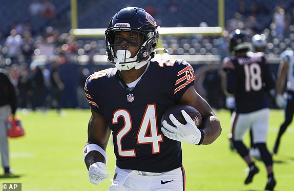 Chicago Bears running back Khalil Herbert runs the ball during warmups before an NFL football game against the Carolina Panthers on Sunday, Oct. 6, 2024, in Chicago. (AP Photo/Nam Y. Huh)