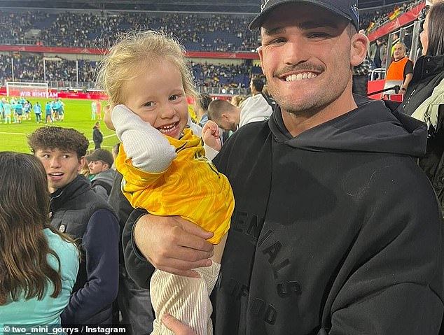 The running back also attended a Matildas game (pictured with Katrina Gorry's daughter Harper)