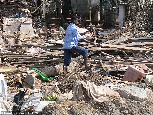 A man looks at the rubble in Galle, southern Sri Lanka, after the tsunami devastated the small island country, as well as Thailand and Indonesia.