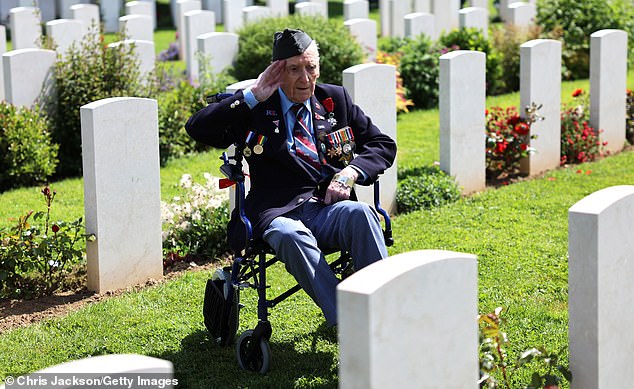 Ronald Hendrey salutes as he visits the gravestone of a comrade at Bayeux War Cemetery on June 5 this year. He is one of the few World War II veterans who was able to attend the D-Day event.