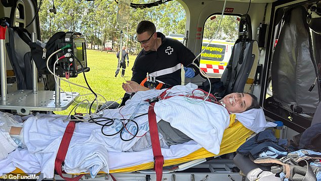 The 33-year-old woman is pictured moments before being airlifted to John Hunter Hospital in Newcastle, where she underwent emergency surgery.