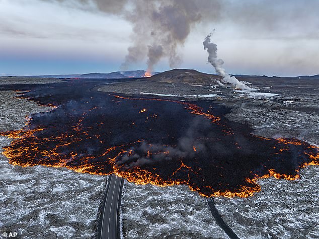 Photo of lava flowing down one of the roads near Grindavik on Thursday morning