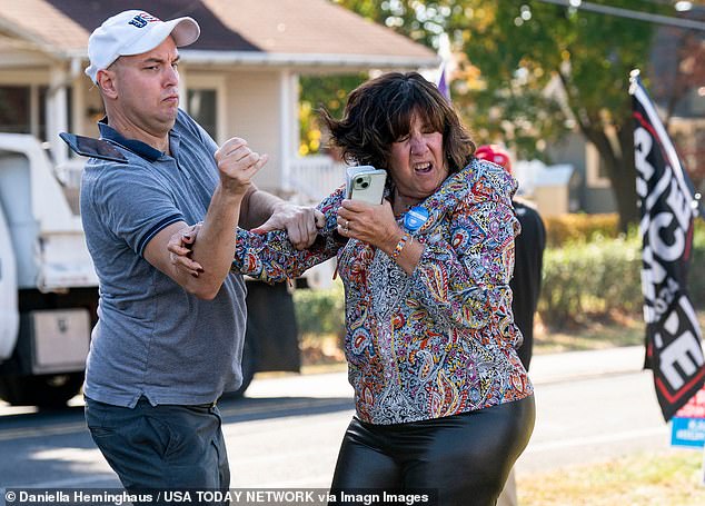 A Trump supporter, left, confronts a Harris fan outside a Tim Walz event in Bristol Township, Pennsylvania, last week.