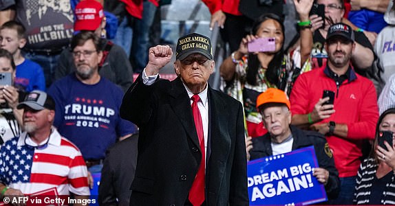 Former US President and Republican presidential candidate Donald Trump raises his fist after speaking at the end of a campaign rally at the Atrium Health Amphitheater in Macon, Georgia, on November 3, 2024. (Photo by Elijah Nouvelage/AFP) (Photo by ELIJAH NOUVELAGE/ AFP via Getty Images)