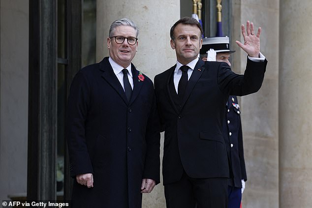 French President Emmanuel Macron (right) waves flanked by British Prime Minister Keir Starmer upon arrival at the Elysee Presidential Palace in Paris, on November 11, 2024.