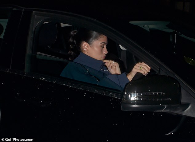 The former footballer was seen leaving separately from his American photographer girlfriend, who was later photographed driving the couple home.