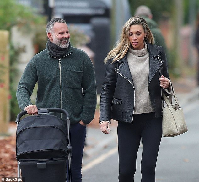 The former Manchester United footballer, 50, couldn't wipe the smile off his face as he pushed the stroller after becoming a father for the third time.