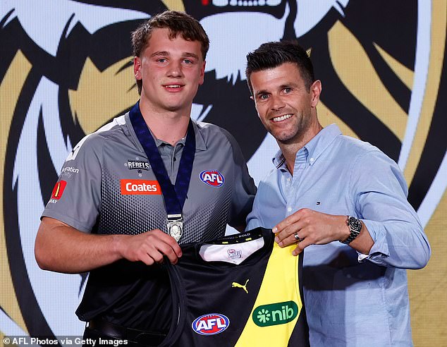 Number one draft pick Sam Lalor (left) received his Richmond guernsey from club legend Trent Cotchin (right).