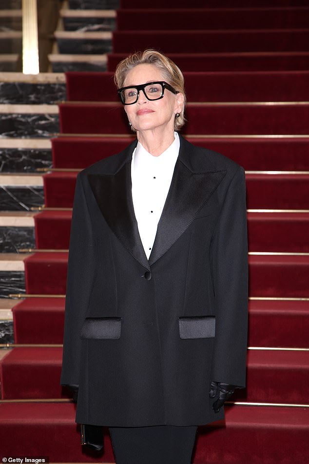 To accessorize, Sharon stepped out wearing silk gloves, large square glasses, and black pearl earrings.