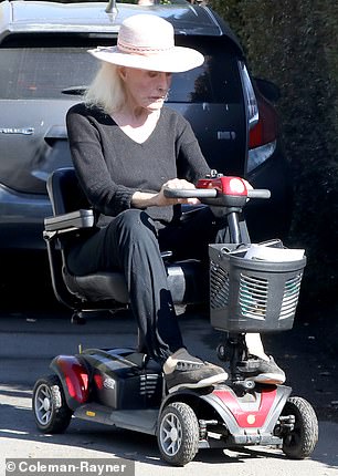 He took his scooter for a spin through the rose garden after packing his food in the basket on the front handle.