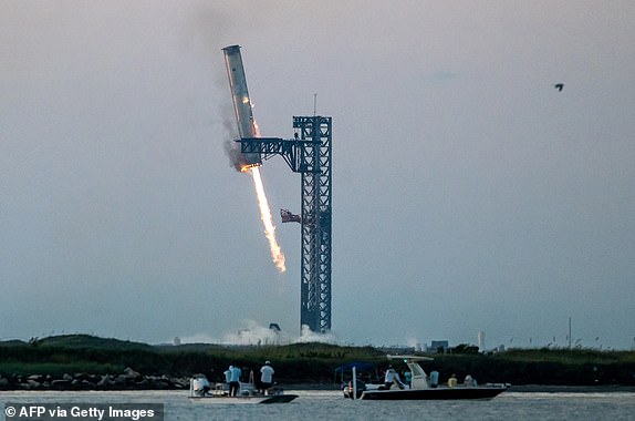 TOPSHOT - Starship's Super Heavy Booster is secured on the launch pad at Starbase near Boca Chica, Texas, Oct. 13, 2024, during Starship Flight 5 testing. SpaceX successful "caught" the booster from the first stage of its Starship megarocket on Sunday as it returned to the launch pad after a test flight, a world first in the company's quest for rapid reusability. (Photo by SERGIO FLORES/AFP) (Photo by SERGIO FLORES/AFP via Getty Images) *** BESTPIX ***