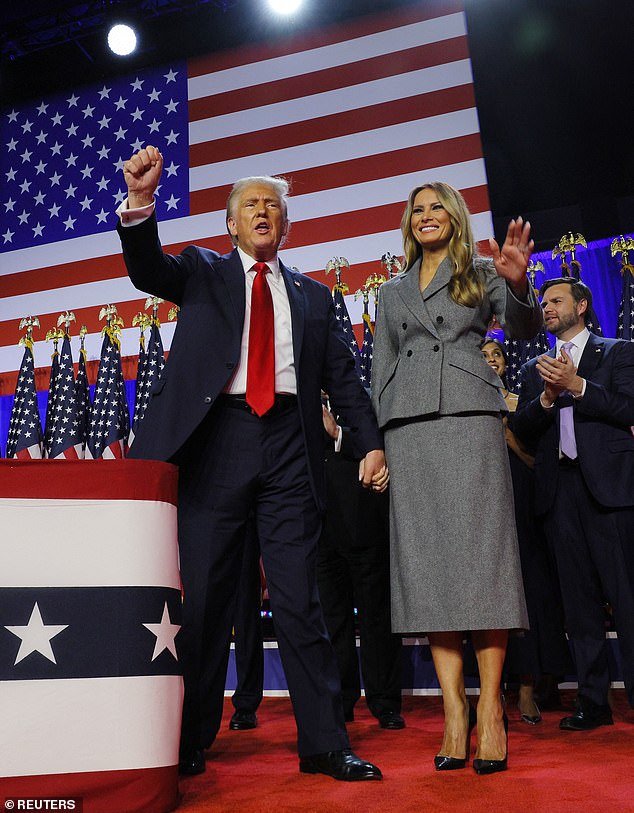 Donald Trump pumps his fists into the crowd at the Palm Beach County Convention Center while holding hands with his wife Melania.