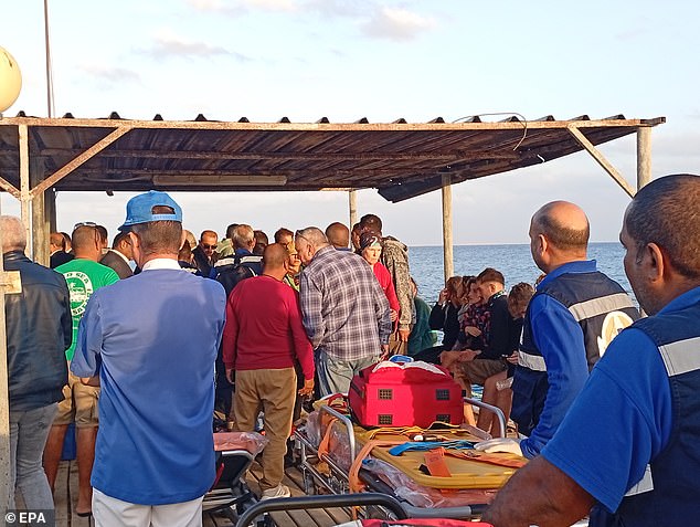 Medics and people wait for possible survivors after a ship sank in a port in Marsa Alam, Red Sea governorate, Egypt, Nov. 25, 2024.