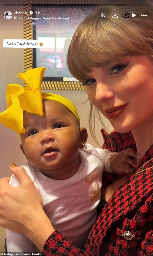 Taylor Swift holds Chariah Gordon's daughter Ci during her latest visit to Arrowhead Stadium