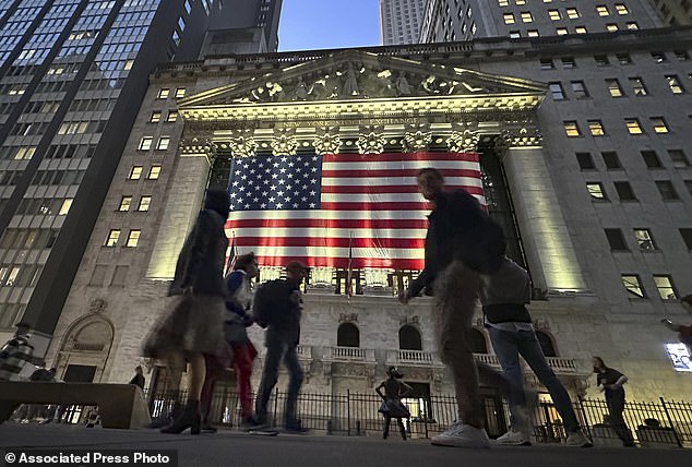 People walk past the New York Stock Exchange in New York's financial district on Tuesday, Nov. 5, 2024. Stocks rose Wednesday morning after Trump regained the presidency.