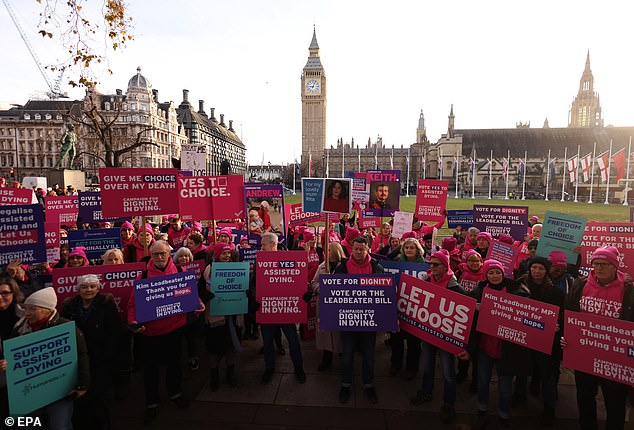 Activists supporting the Dignity in Dying campaign group protest in Parliament Square ahead of today's vote.