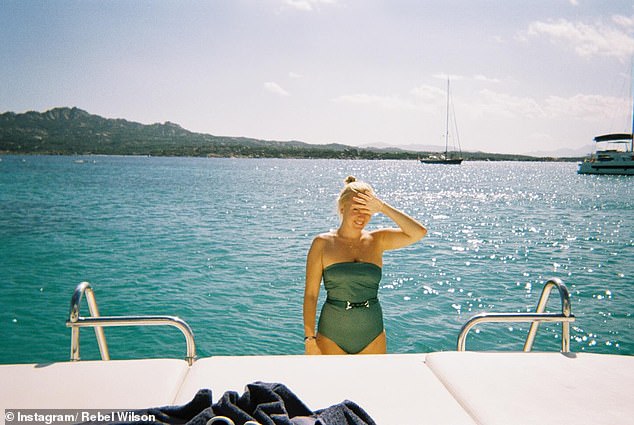 In one photo, Rebel and Ramona snuggle aboard a yacht before the designer takes a dip.