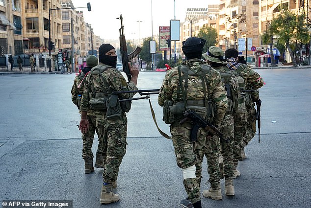 Anti-government fighters patrol in central Aleppo on November 30, 2024.