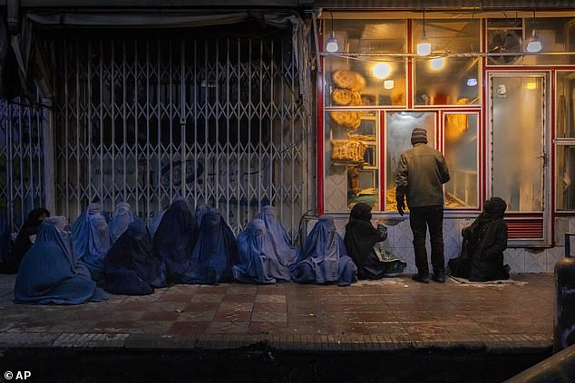 File image of women and children ordering bread outside a bakery in central Kabul, Afghanistan, January 14, 2022