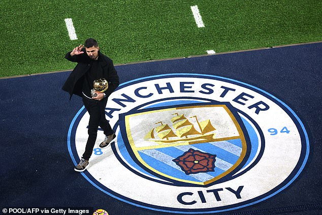 An injured Rodri shows his Ballon d'Or to the Manchester City fans