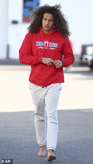 Hollins wears a 'free the foot' jersey as he arrives at the Buffalo Bills facility