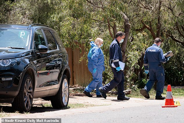 Detectives could be seen scouring the area for evidence as they worked the crime scene.