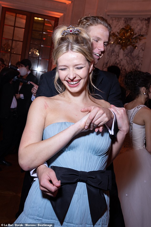 The 20-year-old daughter of Gwyneth Paltrow and Coldplay's Chris Martin stunned in a sky blue strapless dress from Valentino's Spring 2025 collection as she gracefully danced with her eligible date.