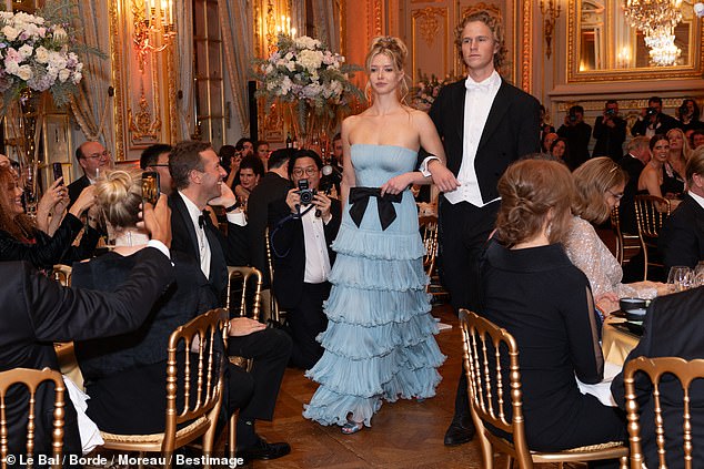 Leo and Apple linked arms as they entered the luxurious ballroom before she blew her proud father Chris a kiss.