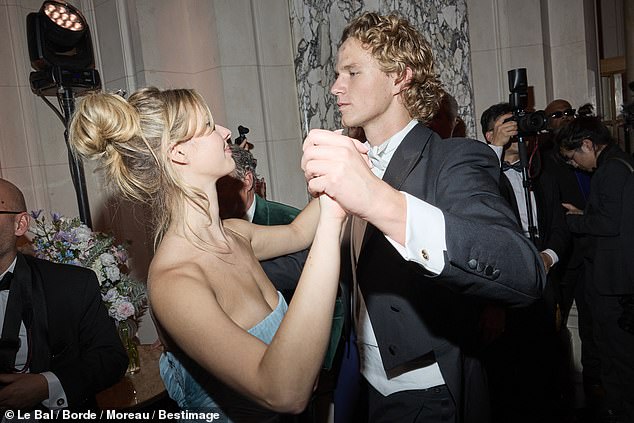 Her famous parents Chris and Gwyneth couldn't take their eyes off their daughter as she danced around the room.