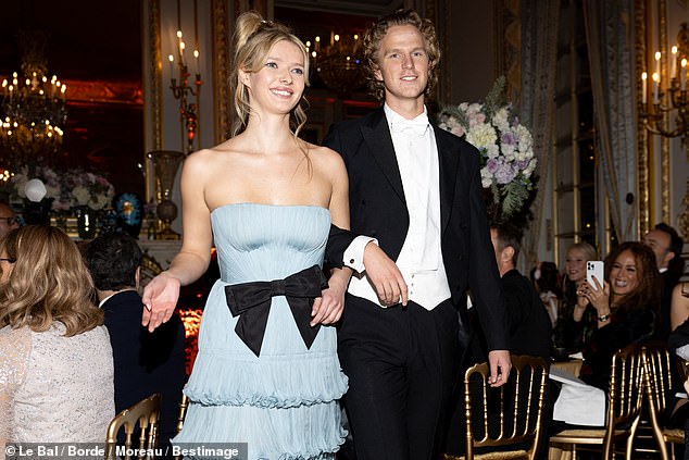 The couple was all smiles as they entered the ballroom.