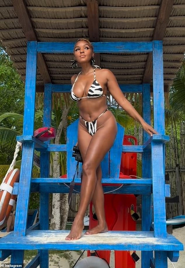 The style maven posed up a storm at a lifeguard stand.