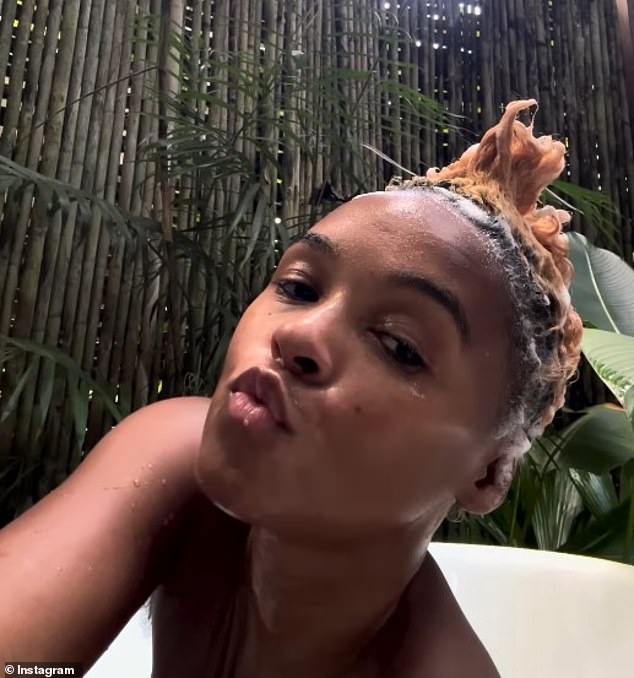 Monae added a makeup-free clip of her soaking in an outdoor shower and playfully styling her short locks into a Mohawk.