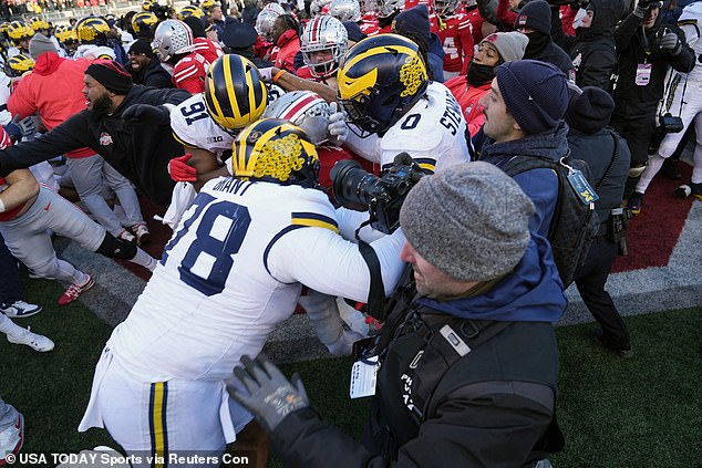 Michigan-Ohio State began the day with a violent fight sparked by a flag-planting incident.