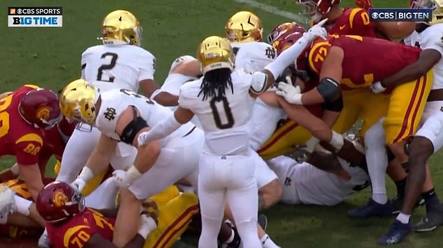 Notre Dame's Rylie Mills also threw a punch during the game against USC at a fallen opponent.