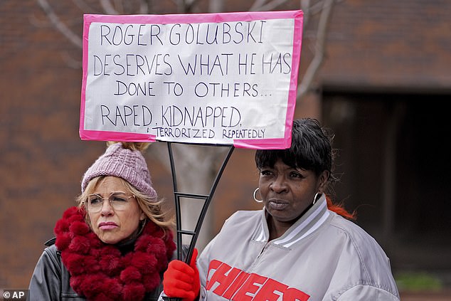 Lesa Mensa, left, and Anita Randle listen to a speaker during a rally outside the federal courthouse on the opening day of a trial of former detective Roger Golubski