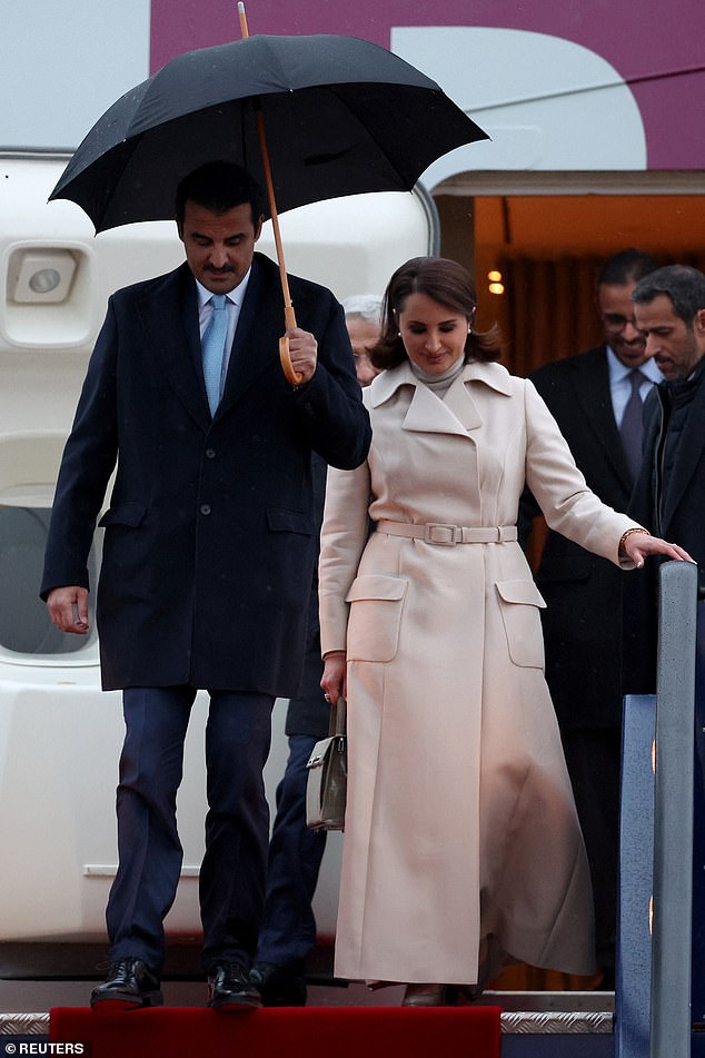 The Emir of Qatar, Sheikh Tamim bin Hamad al-Thani, and his wife, Sheikha Jawaher bint Hamad bin Suhaim Al-Thani, disembark from their plane as they arrive on a state visit to Britain, at Stansted Airport, near London.