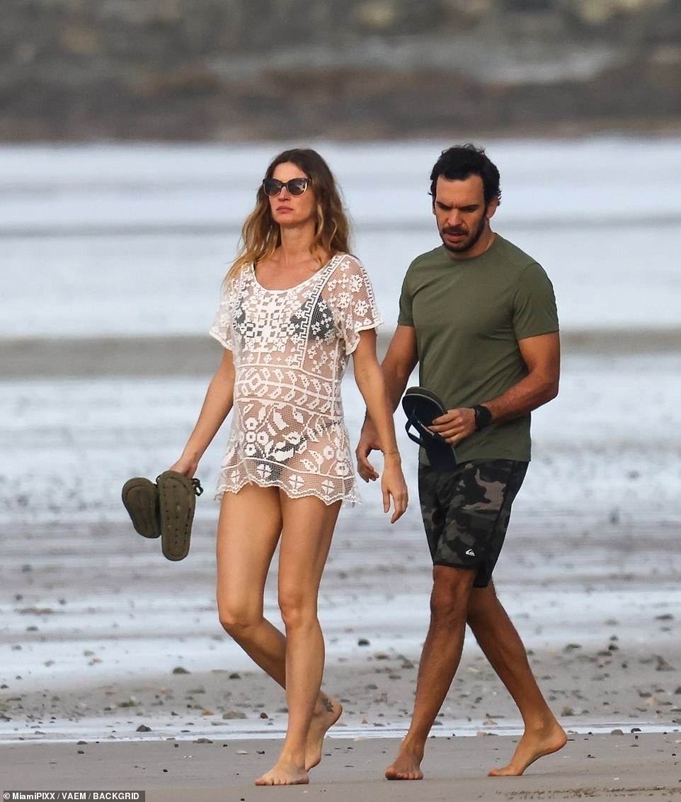 The couple looked blissful as they walked hand-in-hand along a quiet beach in Central America and took in the spectacular ocean views around them.