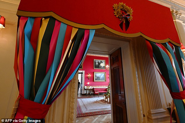 Multicolored ribbon hung framing the doors and windows of the White House