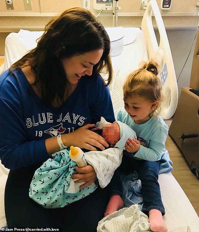 Ms Taylor is pictured with her daughter Scarlet (right) and a baby she was carrying.