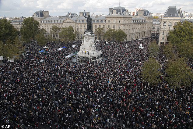 Hundreds of people gather in Place de la République during a demonstration on Sunday, October 18, 2020 in Paris in support of freedom of expression and to pay tribute to a French history professor who was beheaded near Paris.