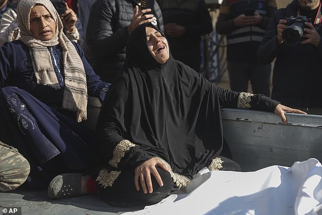 A woman mourns outside hospital after an airstrike killed several people, including children, during an airstrike on a camp for internally displaced persons in Maarat Misreen, north of Idlib, Syria, December 2