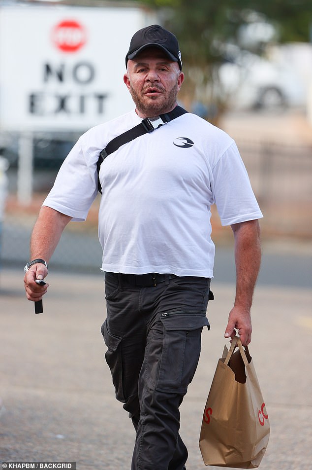 With car keys in hand, the TV presenter accessorized with a pair of sturdy black sneakers while balancing a matching cap on his head.