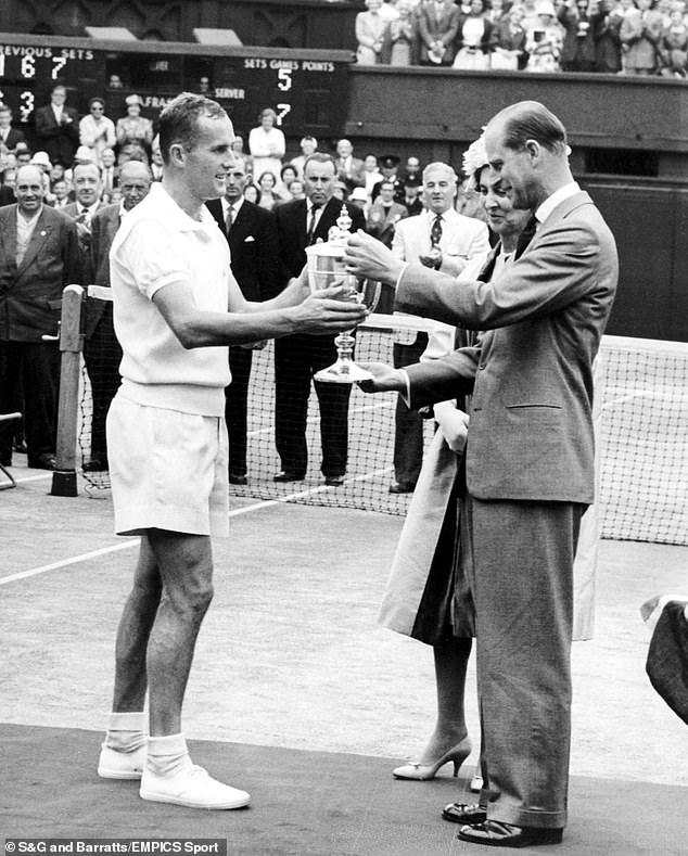 Neale receives the Wimbledon trophy from Prince Philip when he was Duke of Edinburgh