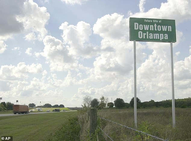 In Polk City, a tongue-in-cheek sign pointing to what could one day be the heart of the sprawling Orlando and Tampa metro areas is seen installed by a private landowner