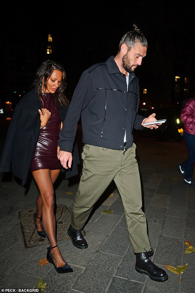 The former Liverpool striker was seen heading to the event alongside his new partner, who showed off her deep tan in a burgundy leather mini dress.