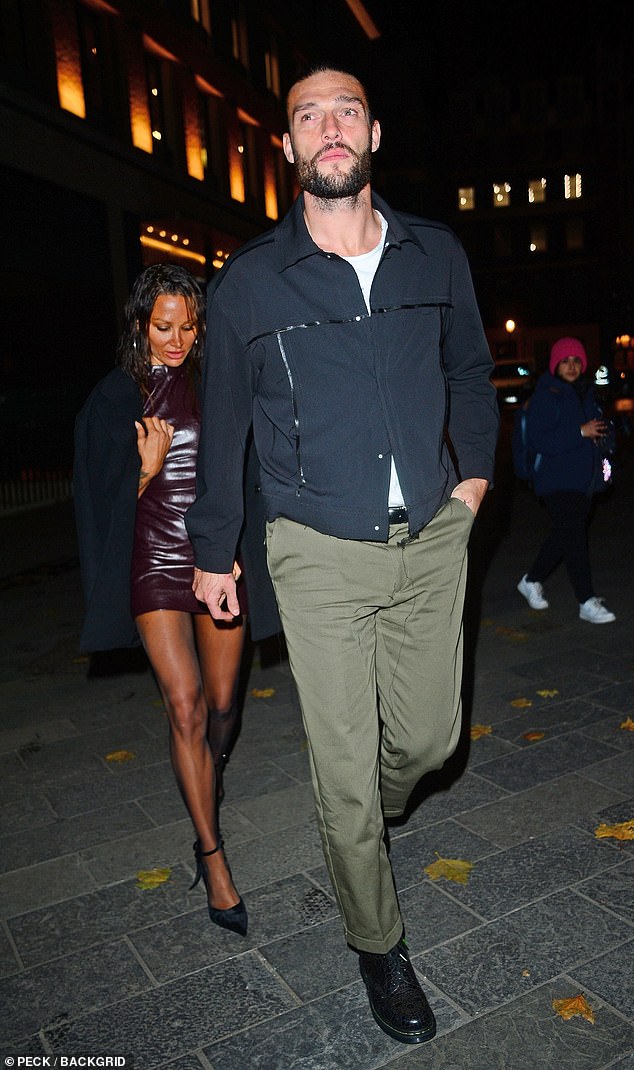 While Andy kept it casual in a black zip-up jacket which he paired with khaki pants.