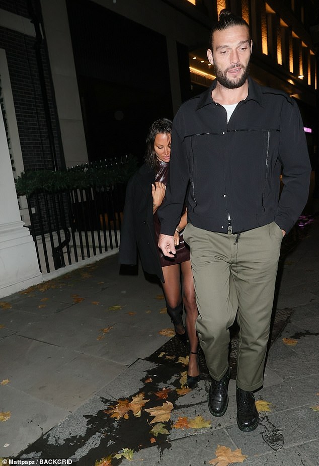 The athlete held Lou's hand as they entered the event together.