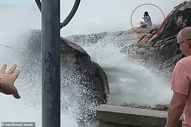 She was seen sitting on her yoga mat as the waves grew stronger.