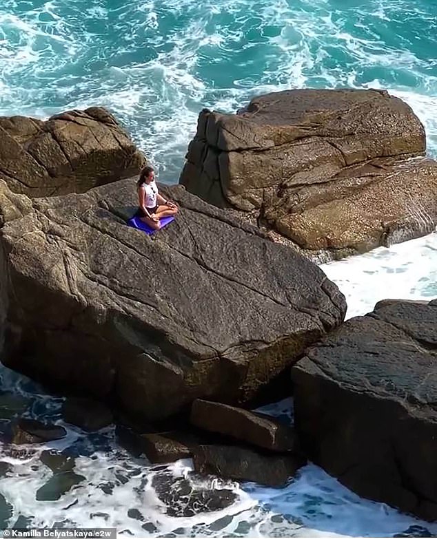 Kamila had been sitting on the rocks, apparently meditating, as the waters became more violent.