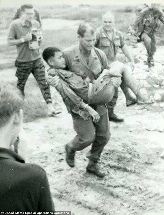 Howard carried the NVA soldier back to the camp for questioning